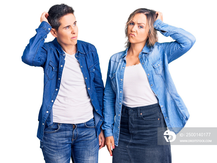 Couple of women wearing casual clothes confuse and wondering about question. uncertain with doubt, thinking with hand on head. pensive concept.