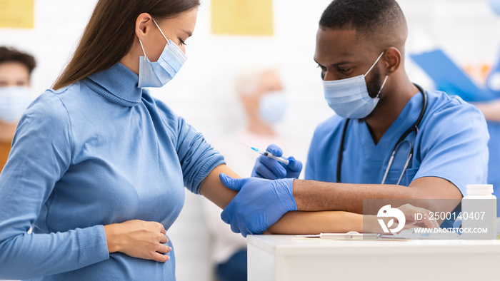 Doctor Injecting To Pregnant Woman Covid-19 Medicine Injection In Clinic