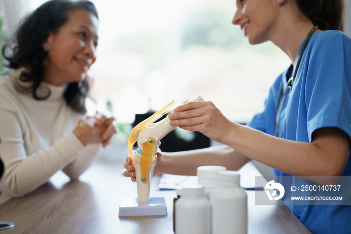 Portrait of a female doctor talking to an elderly patient about osteoarthritis.