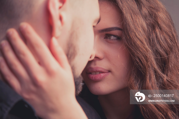 Romantic couple. Close up portrait of attractive brunette girl and guy close to each other. Tenderness and love concept.