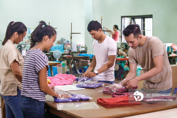 workers at textile factory packaging their products