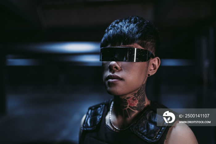 Cyberpunk style. Tattooed guy in one city. Cyber glasses.