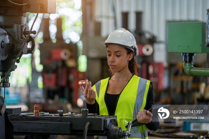 Portrait of industrial woman engineer working in a factory.