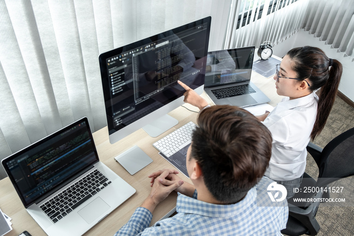 Team of two professional programmers working on website projects in software development and making coding and typing data code password security in office