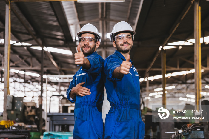 Portrait group of Industry factory maintenance engineer wearing safety uniform and safety helmet standing and smile with thumbs up in factory background. Industry, Engineer, construction concept.