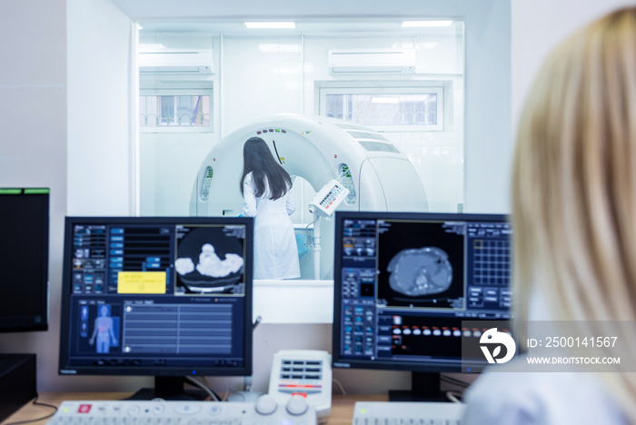 Radiologist in the control room of computed tomography at hospital