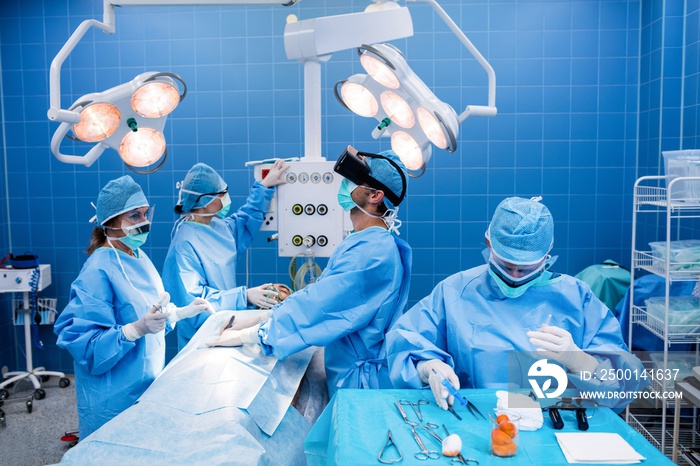 Surgeons performing operation in operation room