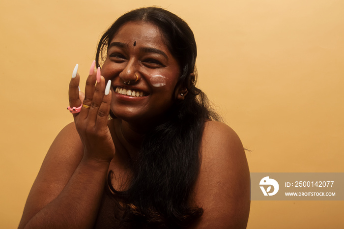 South Asian female solo lifestyle studio portrait skin care shot