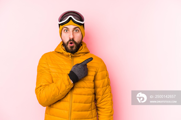 Young skier man isolated pointing to the side