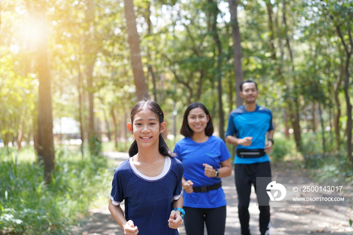 Asian family exercising and jogging together at the park