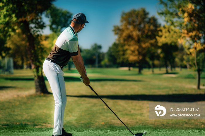 Playing golf. Golfer getting ready for the shot