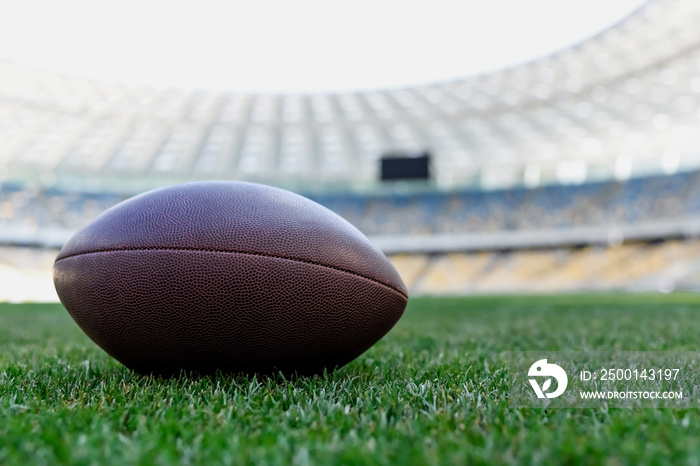 rugby ball on green grass at stadium