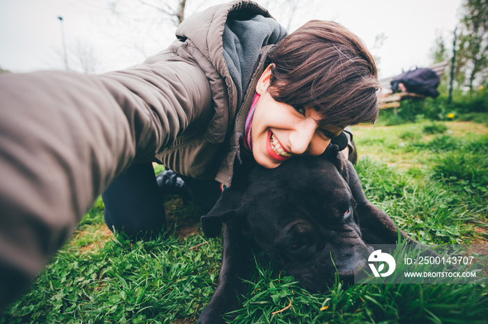 Young woman with dog taking selfie