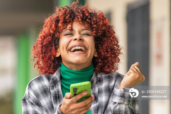 girl with mobile phone or smartphone and expression of success