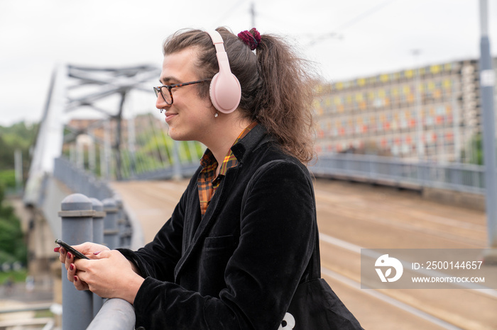 Side view of man listening music on city street