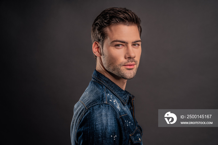 Advertisement concept, side view half face profile with copy space of perfect man loking to the camera standing over gray background