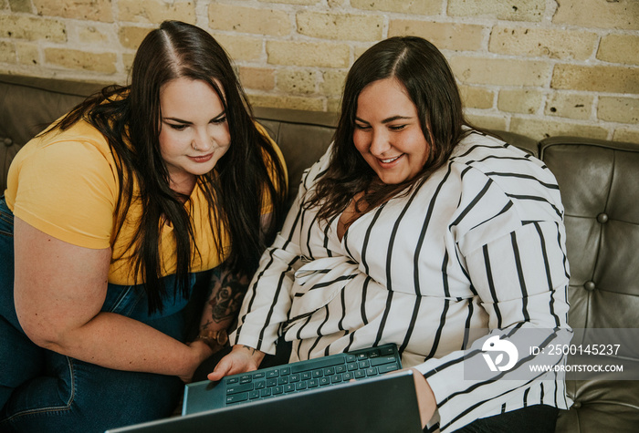 close up of 2 women looking at laptop