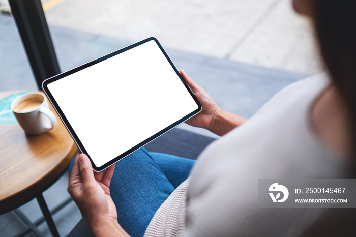 Mockup image of a woman holding digital tablet with blank white desktop screen