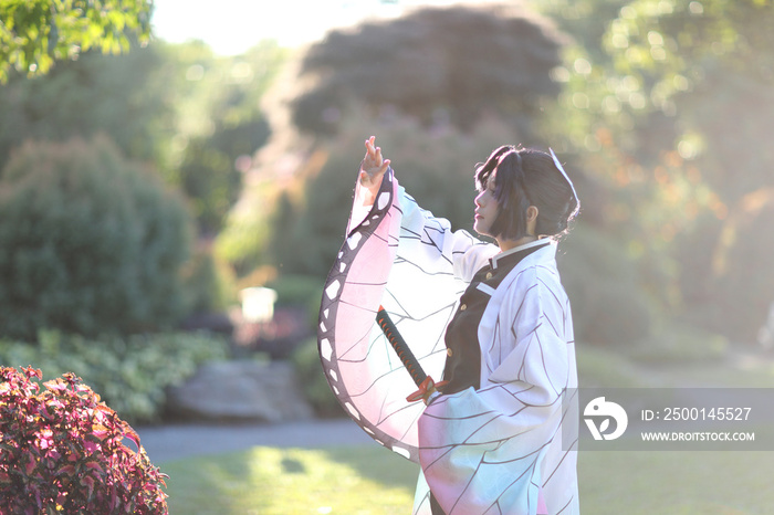 Japan anime cosplay portrait of girl with comic costume with japanese theme garden