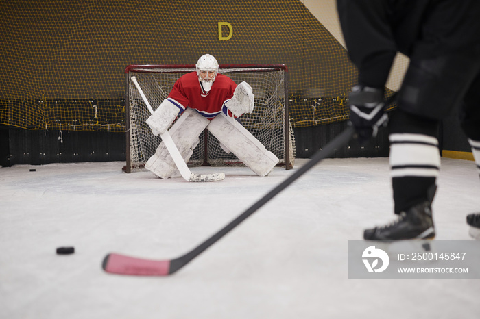 Background image of hockey goalkeeper ready to defend gate in rink, copy space