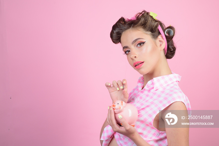 pinup girl with fashion hair. pretty girl in vintage style. pin up woman with trendy makeup. loan. Money. Housewife. retro woman with moneybox, copy space. Rich and successful