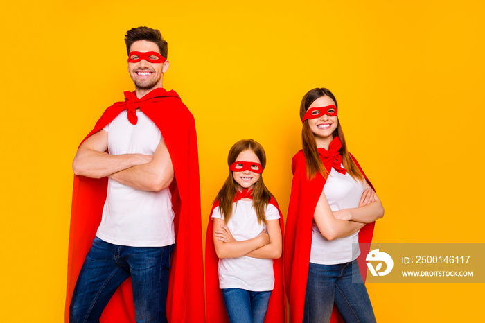 Three family members playing cartoon incredible characters wear carnival costumes isolated yellow background