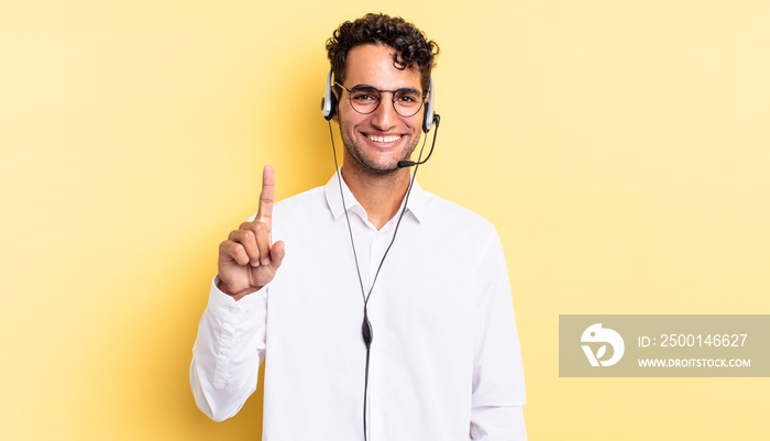 hispanic handsome man smiling proudly and confidently making number one. telemarketer concept