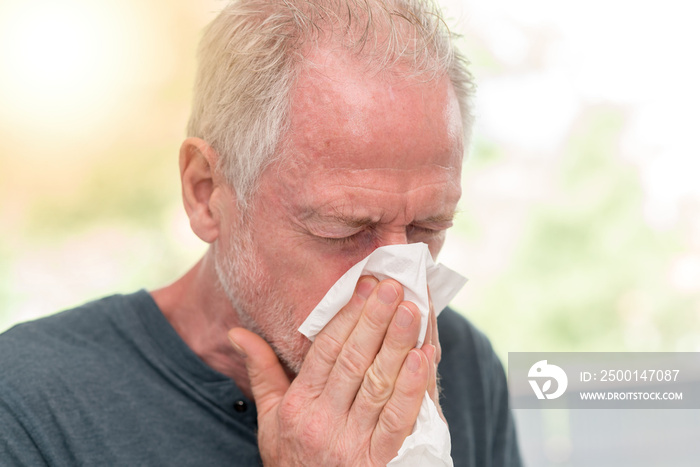 Man blowing his nose, light effect