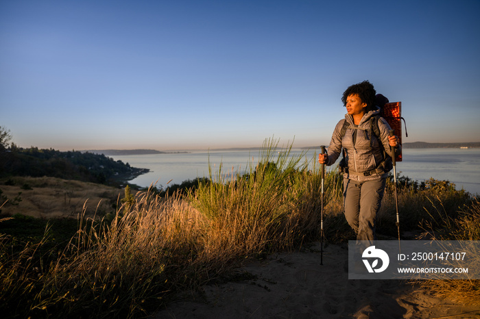 U.S. Army female soldier putting in the miles with an early morning hike in the NorthWest.