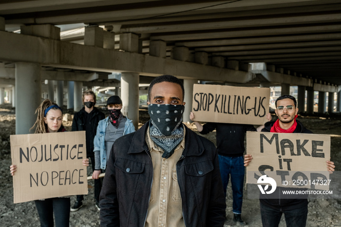 Group of extremists with banners under bridge