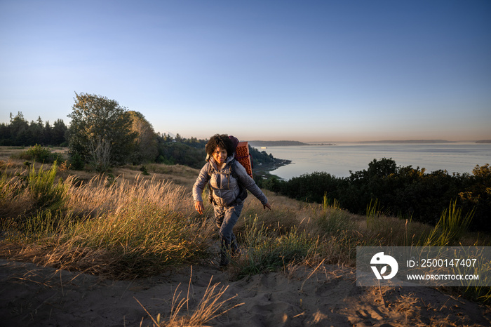 U.S. Army female soldier putting in the miles with an early morning hike in the NorthWest.