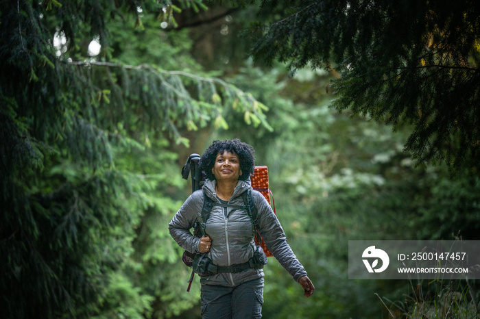 U.S. Army female soldier putting in the miles with an early morning hike in the NorthWest.