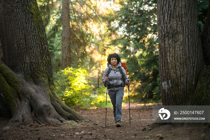 U.S. Army female soldier putting in the miles with an early morning hike in the NorthWest.