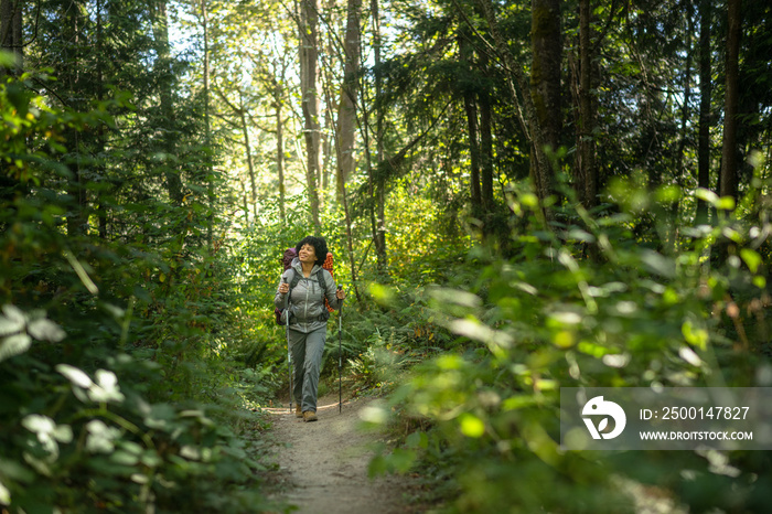 U.S. Army female soldier putting in the miles with an early morning hike in the NorthWest.