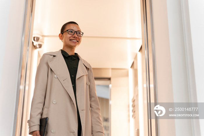 Non binary office worker walking in hallway