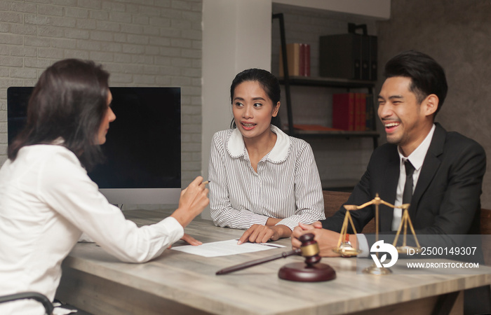 Notary with Client trust team promise winning legal case. lawyer giving consultation to couple for insurance life. Experience Attorneys Notary Public advice at Court of Law in Notary Public Office.