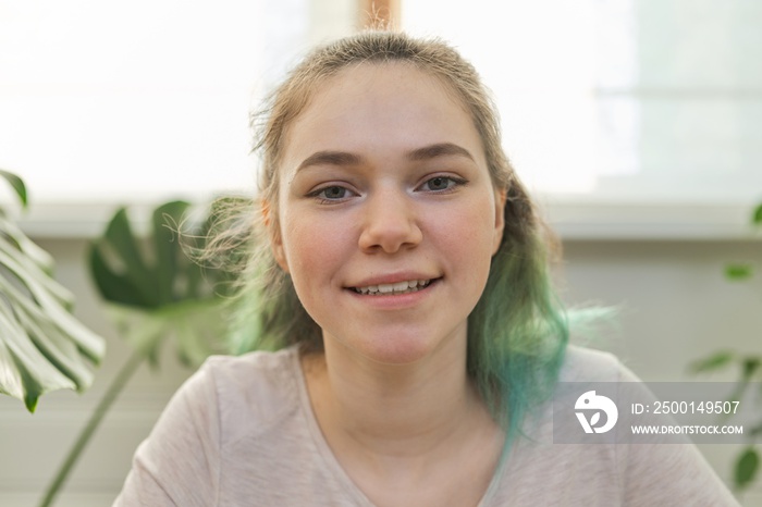 Closeup portrait of talking teenage girl looking at video camera