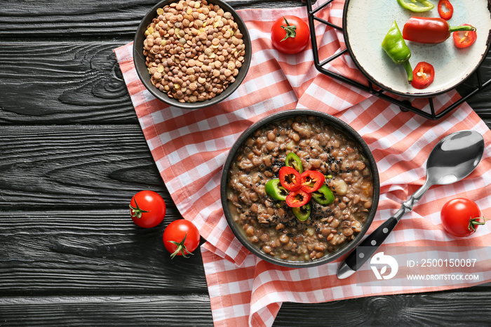 Bowl of tasty lentils soup on table