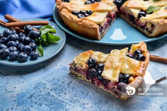 Tasty blueberry pie on color background