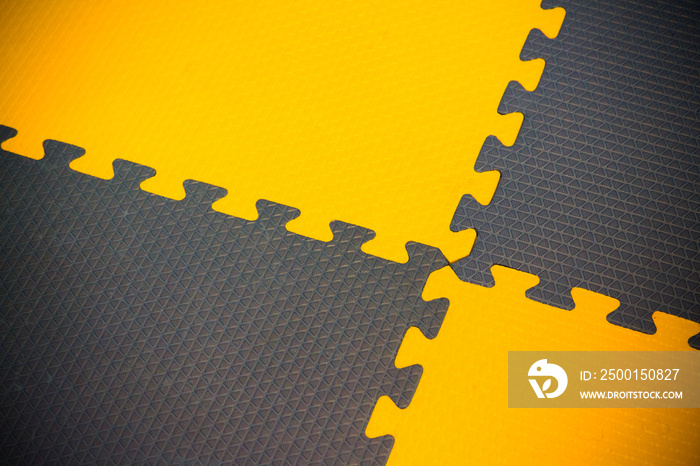 yellow and black jigsaw puzzle mat for kid activity