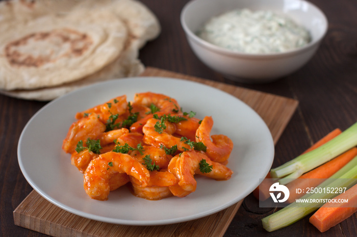 Buffalo shrimp with gorgonzola dip, carrot and celery and pita bread