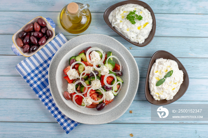 Greek salad with tzatziki, olives and feta cream. Traditional salad, meze,  with olive oil, flat lay