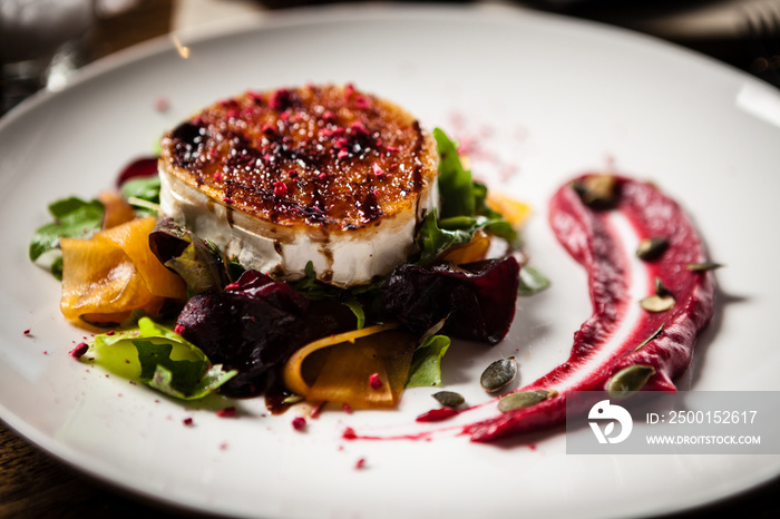 Grilled goat cheese salad served on a plate in restaurant