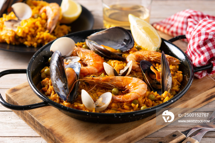 Traditional spanish seafood paella on wooden table