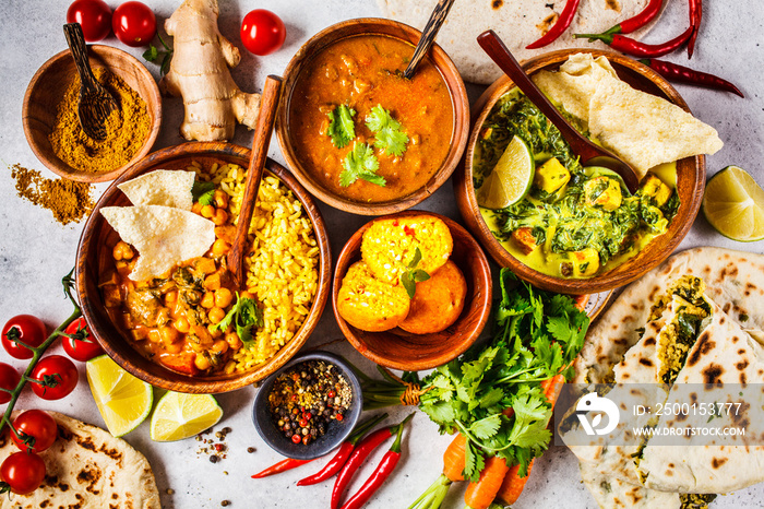 Food traditional Indian cuisine. Dal, palak paneer, curry, rice, chapati, chutney in wooden bowls on white background.