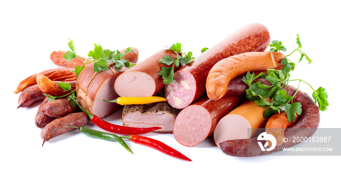 Different sausages and smoked meats with parsley and pepper on white background .