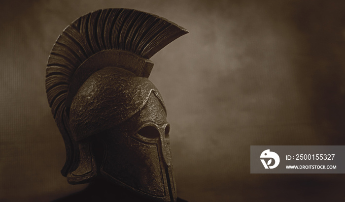 Ancient Spartan (Greek) warrior helmet on a grunge background with copyspace for text. Suitable for TV documentaries, history information etc.