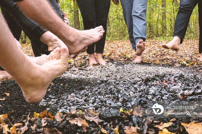 People walk on hot coals barefoot.