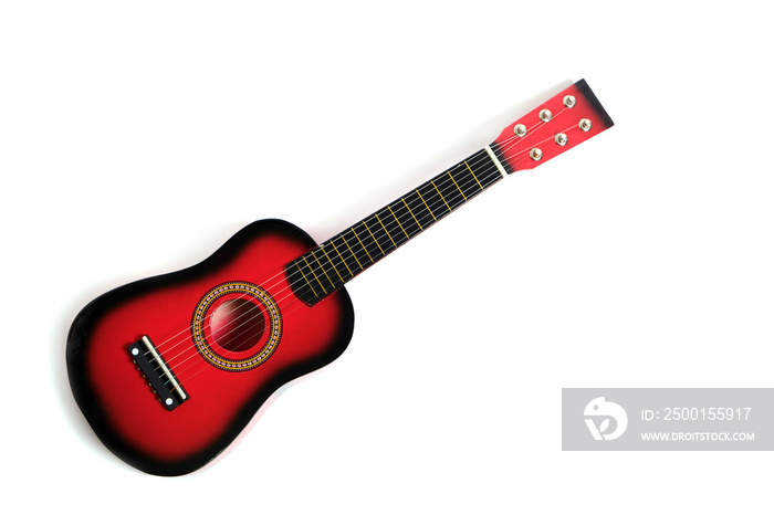 Children’s six string guitar in red on a white background.