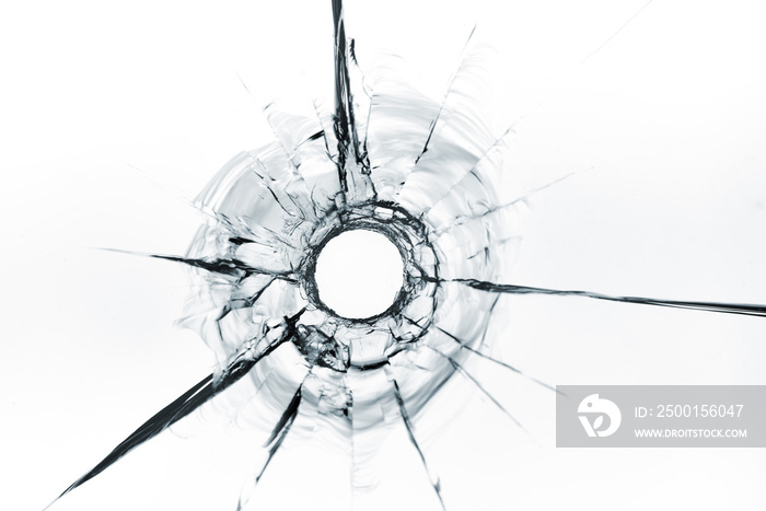 bullet hole in glass close up on white background